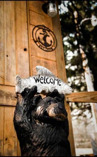 a statue of a bear head on the side of a building at Caddo Cabin on Collier Creek in Norman