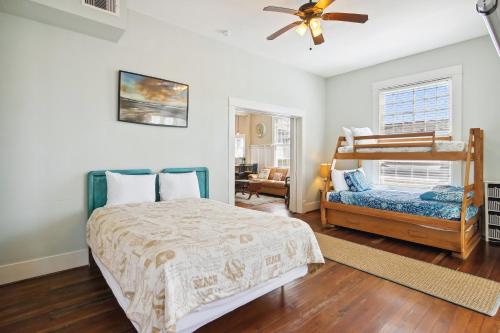 a bedroom with a bed and a bunk bed at The Big Kahuna Manor in Galveston