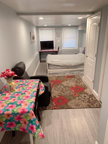 a room with two beds and a table and a rug at Beautiful master bedroom with private bathroom in Baltimore