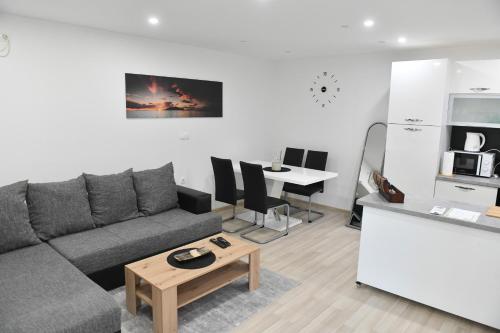 a living room with a couch and a table at Apartman Lucia in Ðakovo