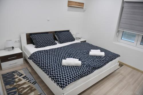 a bedroom with a bed with two pillows on it at Apartman Lucia in Ðakovo