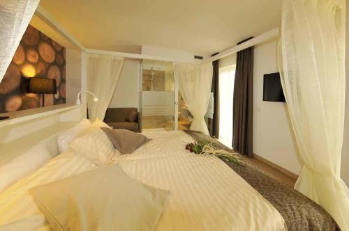 a bedroom with a white bed with flowers on it at Hotel Florida in Levico Terme