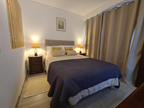 een slaapkamer met een groot bed en 2 lampen bij Desertas View Apartment in Machico