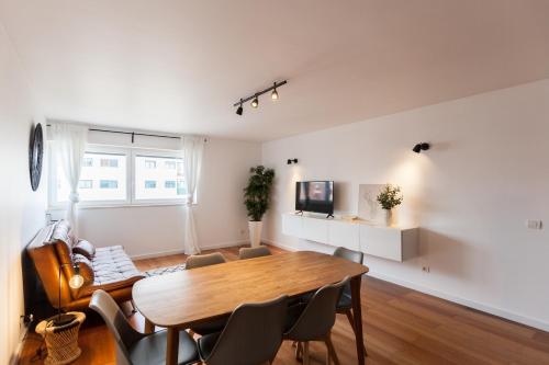 a living room with a wooden table and chairs at FLH Marvila Family Apartment in Lisbon