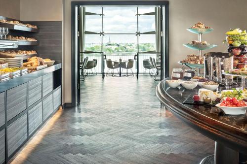 a breakfast buffet in a hotel with a table of food at Le Méridien Hamburg in Hamburg
