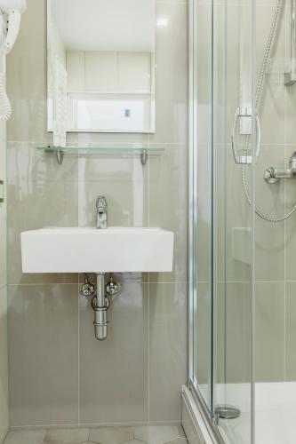 a bathroom with a sink and a shower at Green Town in Vievis