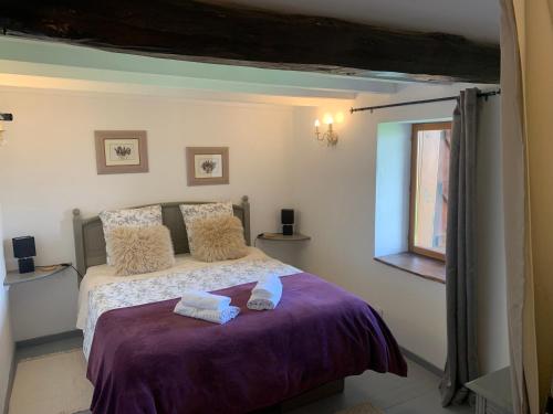 a bedroom with a bed with two towels on it at Les Glycines in Saint-Gaudens