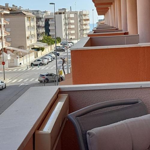a chair sitting on top of a building with a street at Exclusivo apartamento en Canet in Canet de Berenguer