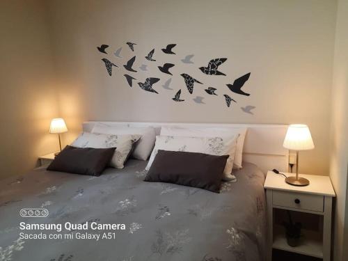 a bedroom with a bed with bats on the wall at Exclusivo apartamento en Canet in Canet de Berenguer