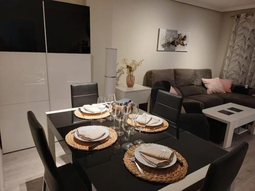 a dining room with a black table and chairs at Exclusivo apartamento en Canet in Canet de Berenguer