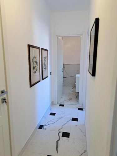 a hallway with white walls and black and white tile at Preia de ma in Levanto
