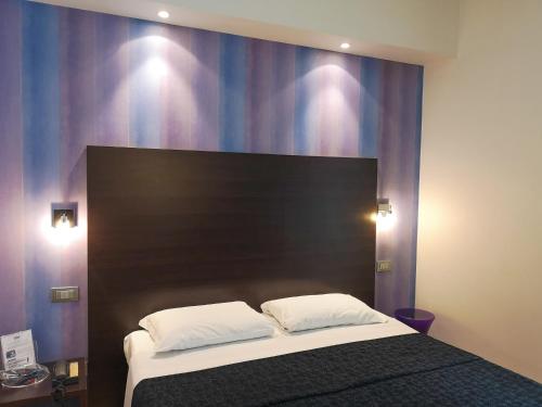 Hotel Perla - The storyhotellerにあるベッド