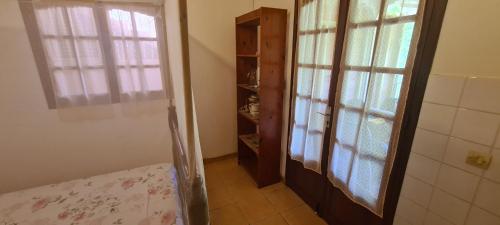 a room with a bed and a window and a closet at Studio pour 2 personnes au calme en Basse-Terre in Vieux-Habitants