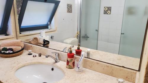 a bathroom with a sink and a mirror at פינה ללב in Rosh Pinna