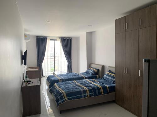 a bedroom with two beds and a window at B70 HC Rental Apartment at TK Central with Swimming Pool & Gyms in Phnom Penh