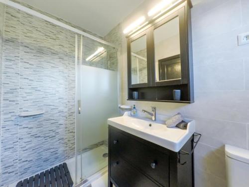 a bathroom with a sink and a shower with a mirror at Casita Montecastillo K4 - 2 bedrooms in Caleta De Fuste