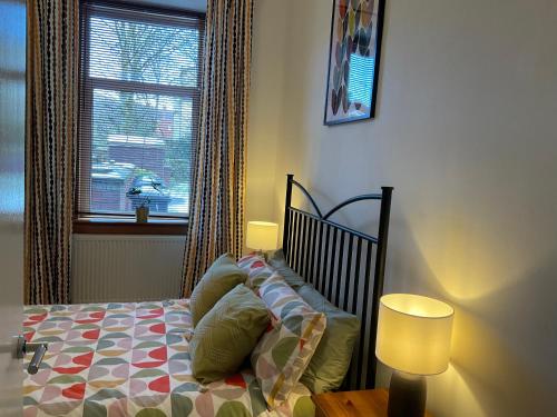 a bedroom with a bed and a window at Hillview, Ground floor apartment, Largs in Largs