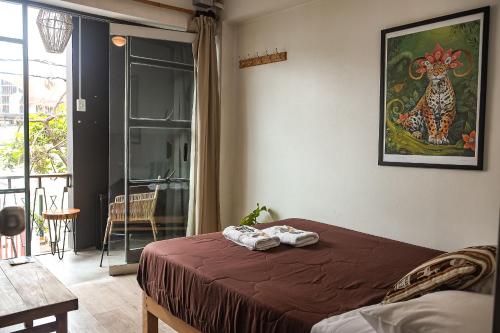 a bedroom with a bed with towels on it at Black Llama Hostel in Lima