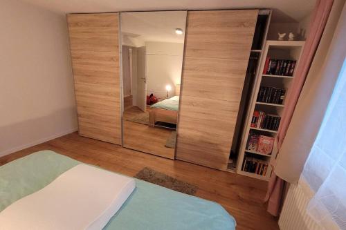 a large mirror in a room with a bedroom at Omi's Nest, für klein und gross in Oberbüren