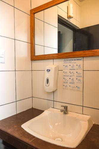 a white sink in a bathroom with a mirror at Black Llama Hostel Miraflores in Lima