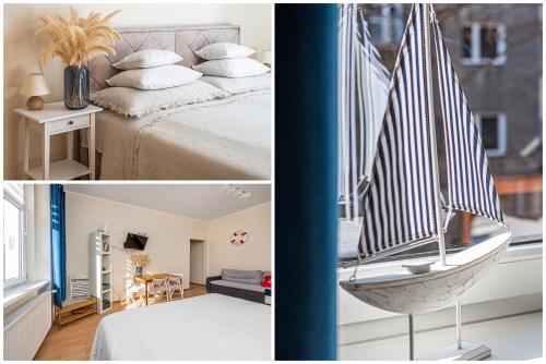 a room with a sailboat on a bed and a room with a room with at Apartament Gdynia in Gdynia