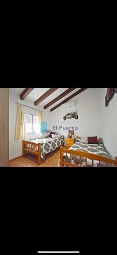 two pictures of a room with two beds at Complejo rural los llanos in Mazarrón