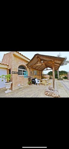 a house with a wooden pavilion in front of it at Complejo rural los llanos in Mazarrón