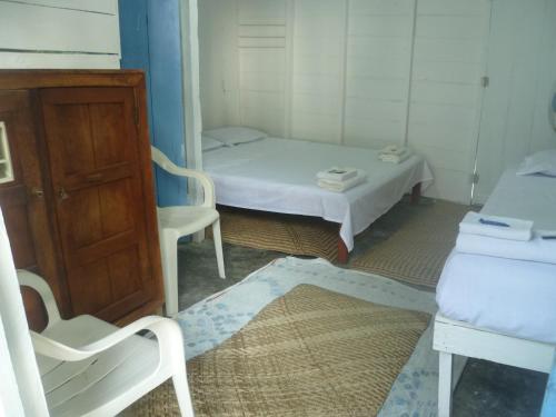 a small room with a small bed and a chair at Cabaña El Bien Germina Ya in El Valle