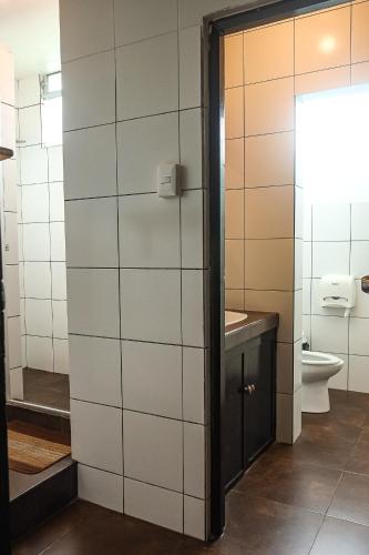 a bathroom with a toilet and a sink at Black Llama Hostel Miraflores in Lima