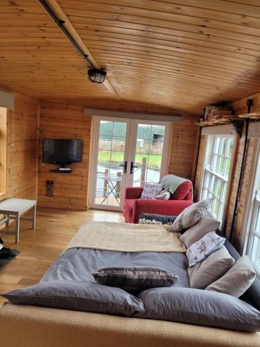 a large bed in the middle of a room at The Cabin at Forestview Farm in Greenisland