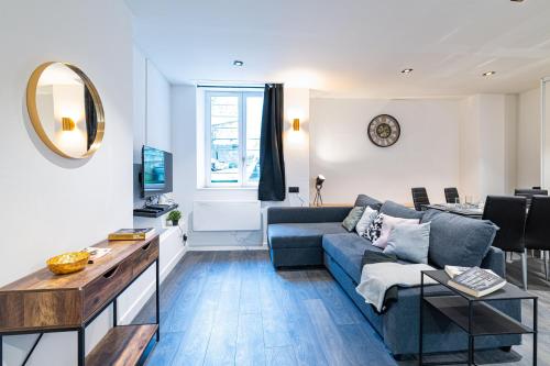 a living room with a couch and a table at Black and White cosy in Sedan