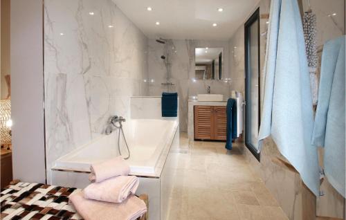 a bathroom with a tub and a sink at Beautiful Home In Rognonas With Outdoor Swimming Pool in Rognonas