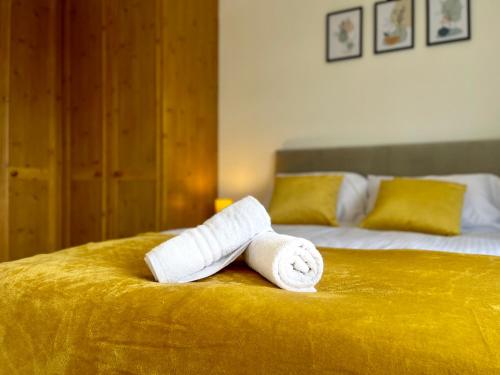a roll of toilet paper sitting on top of a bed at Stylish 3 Bed Chigwell Home with Free Parking in Chigwell