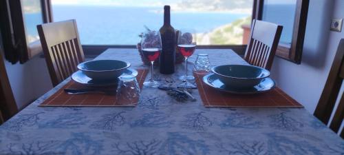 a table with a blue table cloth and wine glasses at Zafiro House in Magomadas