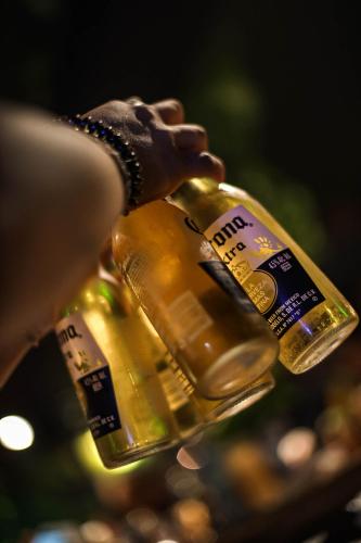 a person is holding a bottle of champagne at Black Llama Hostel Miraflores in Lima