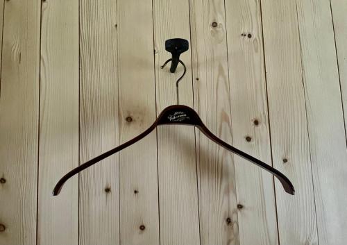 a black object is hanging on a wooden wall at Villa Lofoten - Edvardbua in Kvalnes