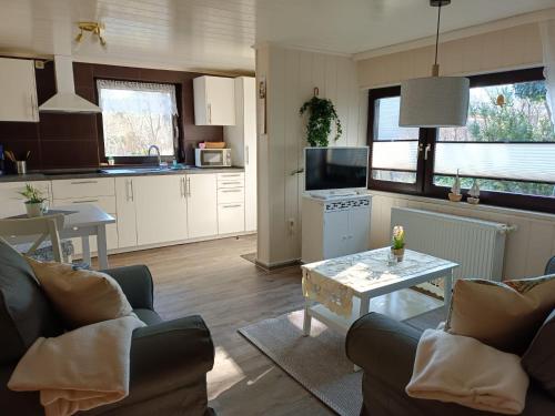 a kitchen and living room with a couch and a table at Ferienwohnung "Juliette" in Zingst