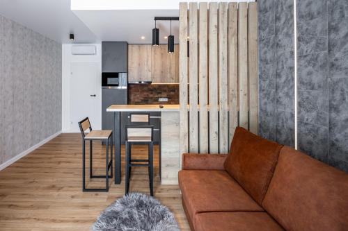 a living room with a couch and a kitchen at New designer apartments in Lviv