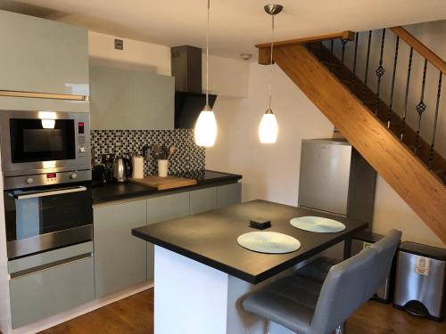 a kitchen with a table and a counter top at Townhouse in Cardigan in Cardigan