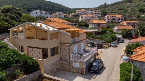 a house with a view of a town at Apartmani Zalaz sunca in Blato