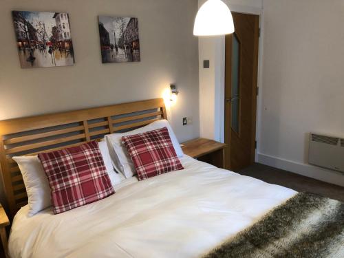 a bedroom with a bed with two pillows on it at Number 19, Cardigan in Cardigan