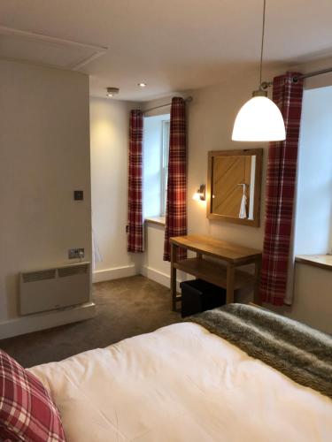 a bedroom with a bed and a mirror and a desk at Number 19, Cardigan in Cardigan