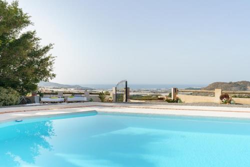 a large blue swimming pool with a view at CORTIJO OHANA in Motril