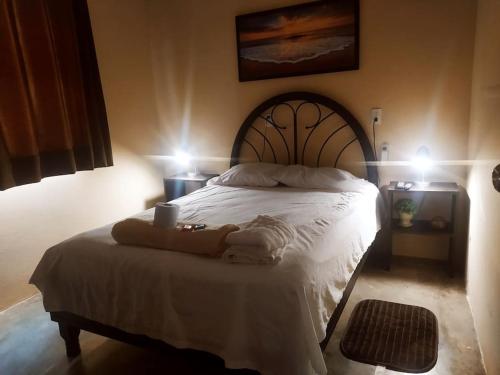 a bedroom with a white bed with two towels on it at Casa de paso independiente para descansar por viaje in Coatzacoalcos