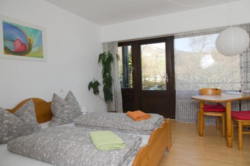 a living room with a couch and a table at Bio-Gästehaus Rhöndistel in Poppenhausen