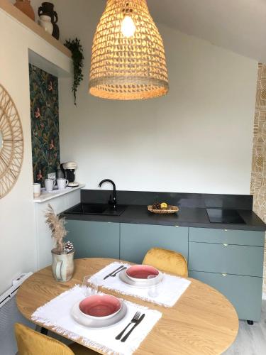 a kitchen with a table with two plates on it at Gîte Loufiosa Vannes in Vannes