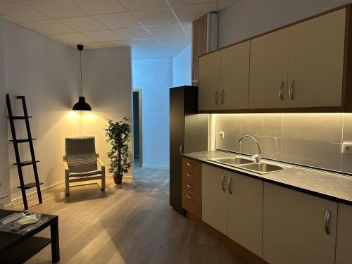 a kitchen with a sink and a chair in a room at Apartamento tipo loft valencia in Paiporta