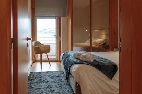 a hotel room with a bed and a mirror at Sweet living Porto in Valbom