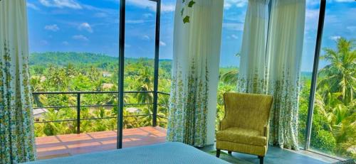 a room with a bed and a view of the ocean at Marino Mirissa in Mirissa