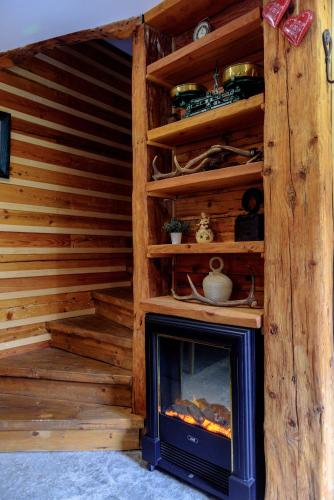 a fireplace in a room with wooden walls at ABC apartments in Kamnik